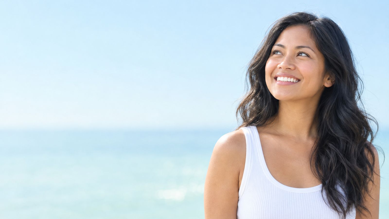 A smiling woman outdoors in soft morning light